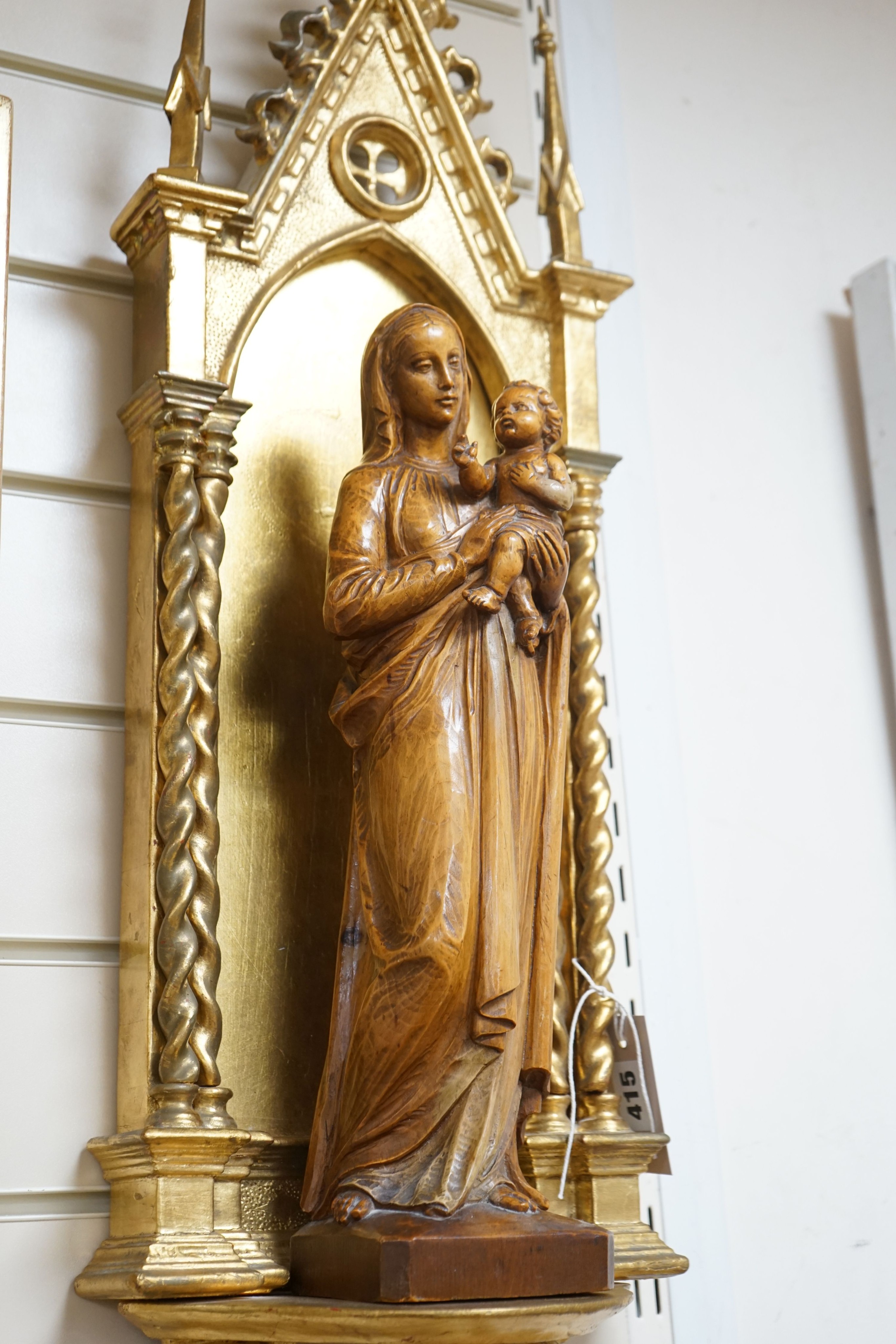 A 19th century architectural gilt niche and a 20th century carved pine group of Madonna and child 88cm